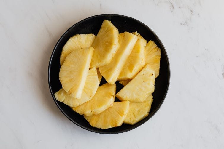 a plate of sliced pineapples on a table